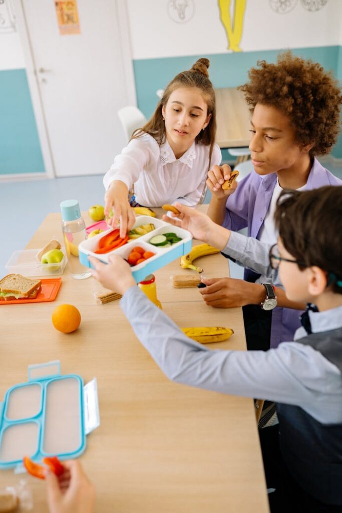 Boy in Blue Long Sleeve Shirt Holding Blue and White Lunch Box